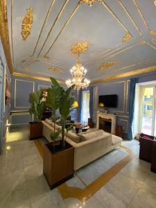 a living room with a couch and a chandelier at Palazzo Cherubini - Wellness e Spa in Rossano