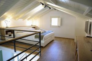 a bedroom with a bunk bed in a loft at Castrusso Castle apartments in Chios