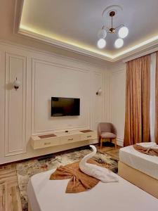 a living room with two beds and a flat screen tv at City View Palace hotel in Cairo