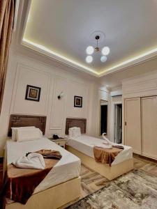 a bedroom with two beds with towels on them at City View Palace hotel in Cairo