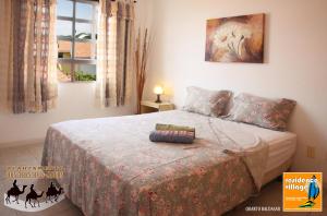 a bedroom with a bed with a blanket on it at Residence Village in Natal +73 photos