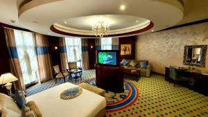 a hotel room with a living room with a television at Jewel Sport City and Aqua Park in Cairo