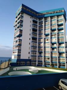 a large building with a golf court in front of it at Apartment with sea view! Mesa del Mar 120 in Santa Cruz de Tenerife