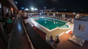 a pool on the roof of a building at night at Hotel-Village Touristique Briech in Briech