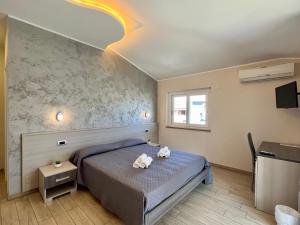 a bedroom with a bed with two teddy bears on it at B&B Galatea in Santa Domenica