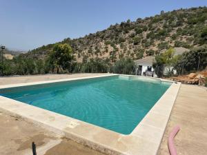 a swimming pool with a mountain in the background at Casa Laera in Algodonales
