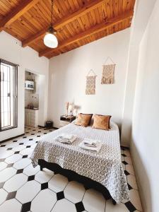 - une chambre avec un lit et un plafond en bois dans l'établissement Departamentos PLENO CENTRO, à Tupungato