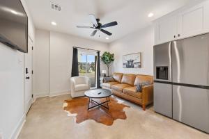 a living room with a couch and a refrigerator at Creole House/KING bed/Relax in Cajun Comfort! in Lafayette