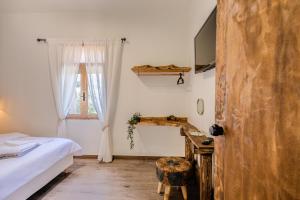 a bedroom with a bed and a desk and a window at To Patriko in Kournás