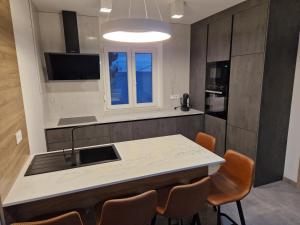 a kitchen with a table and chairs and a sink at Apartment Lisarica in Starigrad-Paklenica