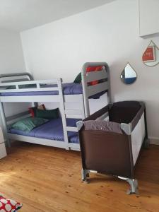 Zimmer mit 2 Etagenbetten und einem Stuhl in der Unterkunft Appartement , 6 personnes, centre-ville, plage à pied in Saint-Jean-de-Luz