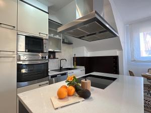 a kitchen with a counter with fruits and vegetables on it at Ático Luz y Mar in Cambados