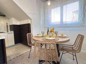 a dining room with a table and chairs in a kitchen at Ático Luz y Mar in Cambados +29 photos