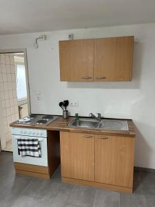a kitchen with a sink and a stove at LittleHome in Hornberg