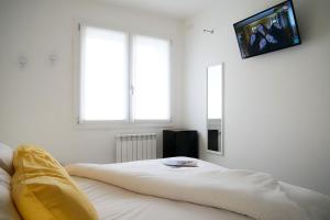 a bedroom with a bed with a yellow blanket on it at Casadamare in Lido di Jesolo