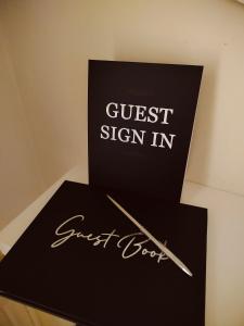 a sign that says guest sign in and a pen at Dandelion home Viareggio centro in Viareggio