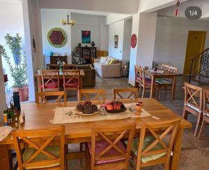 a dining room and living room with a table and chairs at Pırnal Köy Evi in Ayvacık