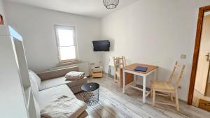 sala de estar con sofá y mesa en FeelGood Ferienwohnung, en Schweina