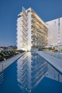 a building with a swimming pool in front of a building at Art Series - The Watson in Adelaide