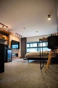 a bedroom with a bed and a television in a room at Urbano in Haifa