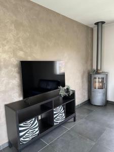 a living room with a flat screen tv on a wall at THE 11 gîte pour vacances ou travail in Comines