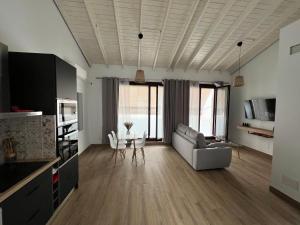 a living room with a couch and a table at M&M Empedrada Apartamentos Jerez in Jerez de la Frontera