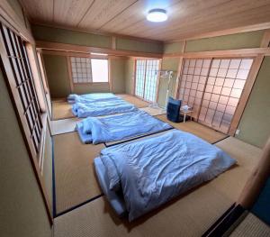 Postel nebo postele na pokoji v ubytování Guesthouse NAMAZU