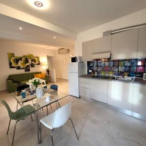 a kitchen and living room with a table and chairs at Angelo&Marì Mountain Lake Iseo Hospitality in Marone