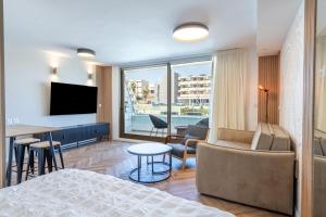 ein Schlafzimmer mit einem Bett und ein Wohnzimmer mit Aussicht in der Unterkunft Sea View Coral - City Center Amazing Pool in Eilat