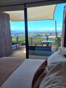 a bedroom with a bed and a view of a table at Colchagua D'vino in Santa Cruz