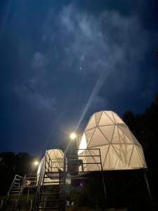 two domes are lit up at night with lights at Croft Yelagiri - glamping stay in Yelagiri