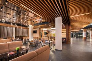a lobby with couches and tables and chairs at Park & Spa Hotel Markovo in Plovdiv