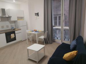 Una sala de estar con un sofá y una mesa y una cocina. en Casa Sauli, en Génova 11 fotos más