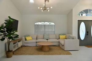 a living room with a couch and a table at Luxury contemporary hidden gem in Lehigh Acres