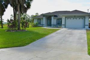 a house with a driveway and a garage at Luxury contemporary hidden gem in Lehigh Acres