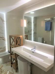 a white bathroom with a sink and a mirror at Luxury Banus Puerto Golf in Marbella