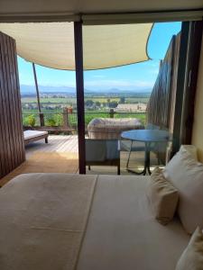 サンタ・クルスにあるColchagua D'vinoのベッドルーム1室(ベッド1台付)、景色を望むバルコニーが備わります。