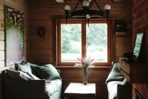 a living room with a couch and a window at Hortus Paradisum in Ikšķile