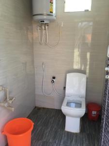 a small bathroom with a toilet and a shower at Croft Yelagiri - glamping stay in Yelagiri