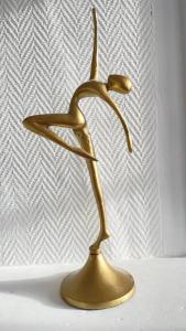 a gold statue of a bird on a table at Jolie maison centre historique in Honfleur