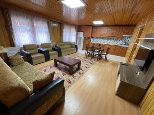 a living room with a couch and a table at Uzungöl Bikka Pansiyon in Uzungöl