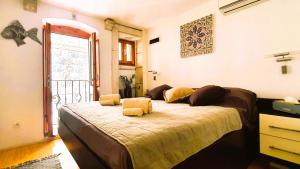 a bedroom with a large bed with yellow pillows at Fidelissima Palace in Korčula
