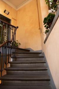 a set of stairs in a building with potted plants at Hotel Giappone - 2 Min Walk Duomo of Florence in Florence