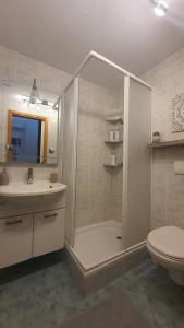 a bathroom with a shower and a sink and a toilet at Fidelissima Palace in Korčula +21 photos