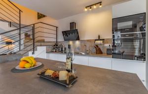 a table with a plate of fruit and a bottle of wine at Gorgeous Home In Vodnjan With Wifi in Vodnjan