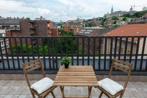 a wooden table and two chairs on a balcony at ROOF TERRACE access CASTLE dst. PARLIAMENT 1stop in Budapest