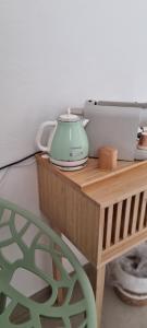 a table with a tea kettle and a printer on it at Casa Brì Boutique Rooms in Santa Teresa Gallura