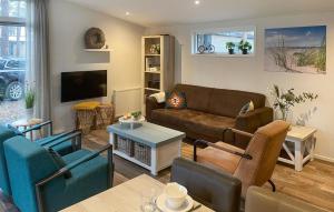 a living room with a couch and a tv at Pet Friendly stacaravan In Hardenberg With Kitchen in Hardenberg