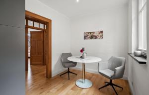 a small white table and two chairs in a room at 1 Bedroom Cozy Apartment In Pommern in Pommern