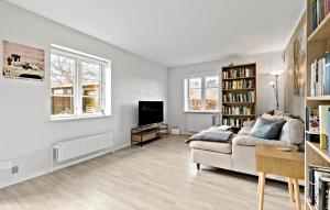 a living room with a couch and a tv at Amazing Home In Skibby With Kitchen in Skibby